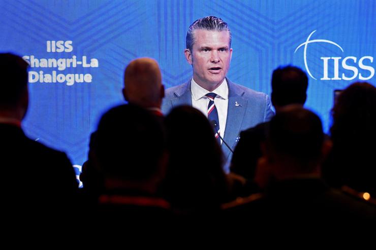 Delegates view U.S Secretary of Defense Pete Hegseth’s speech