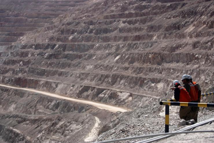 Miners watch from a lookout point at the La Escondida copper mine.