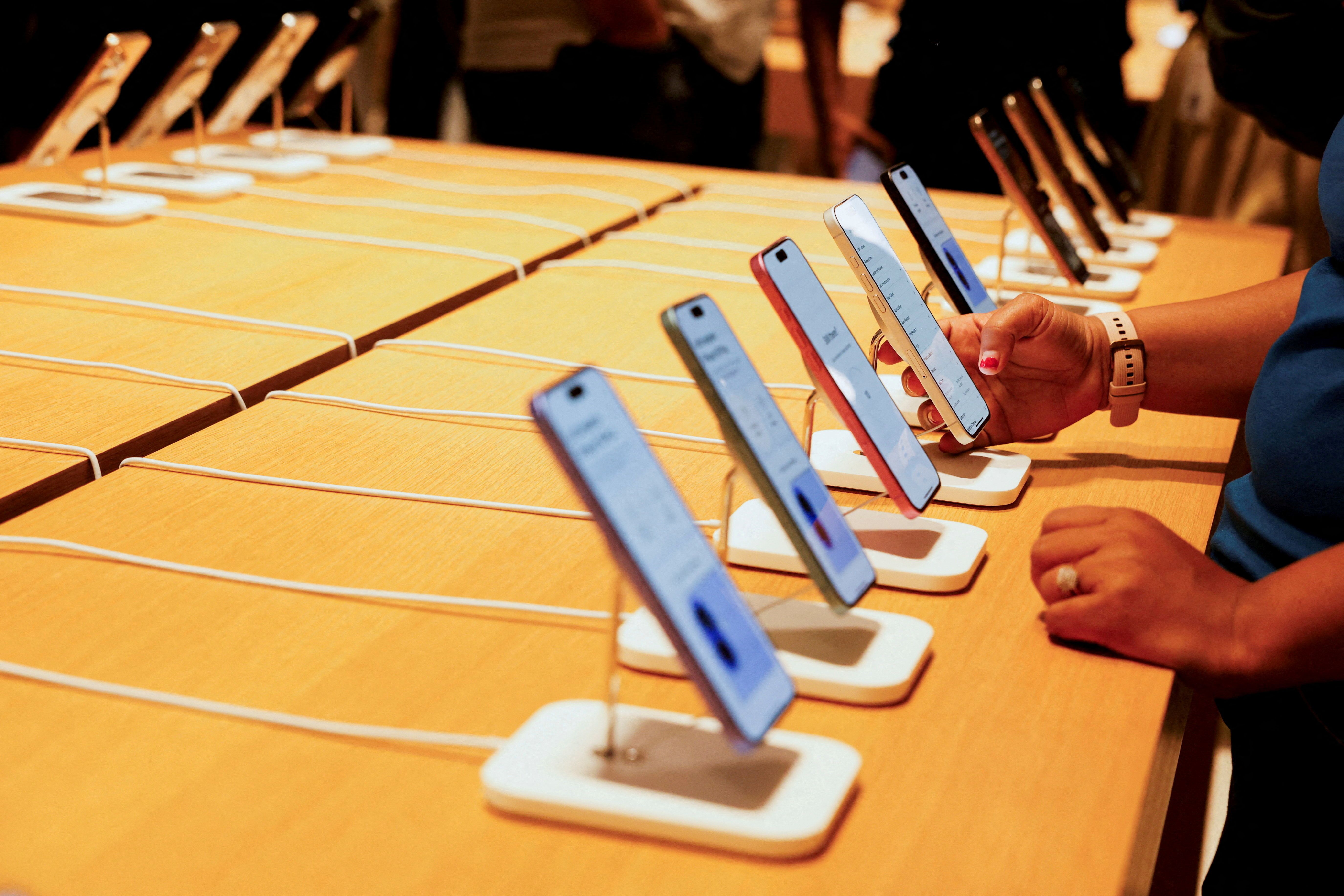 A person holds an Apple iPhone at the company’s first retail store in Bengaluru, India. 