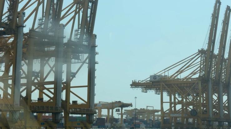 Eaised cranes and stacked containers at Jebel Ali.