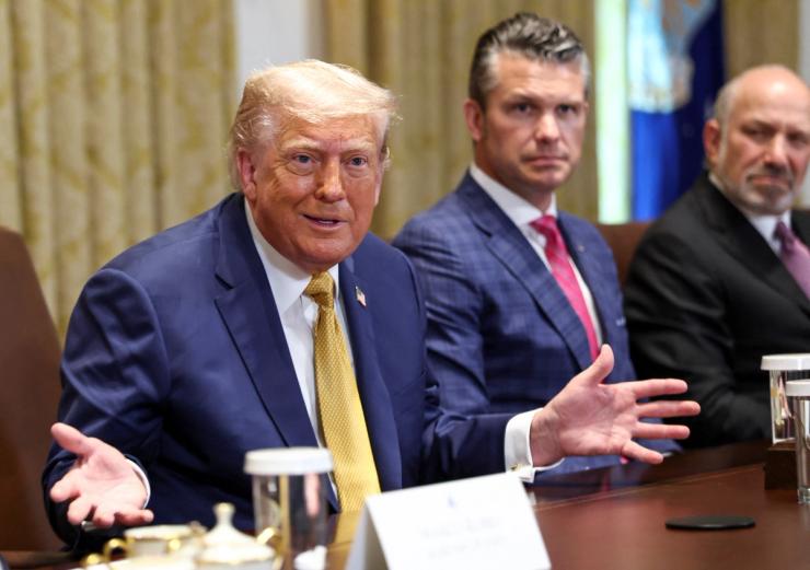 US President Donald Trump speaks next to Defense Secretary Pete Hegseth and Secretary of Commerce Howard Lutnick during a cabinet meeting.
