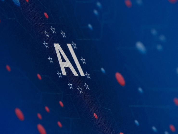 The “AI” acronym is pictured at a tech fair in Paris