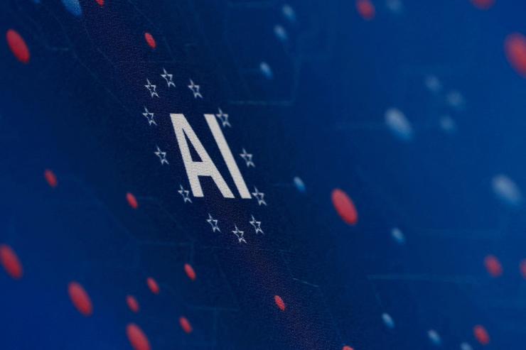The “AI” acronym is pictured at a tech fair in Paris