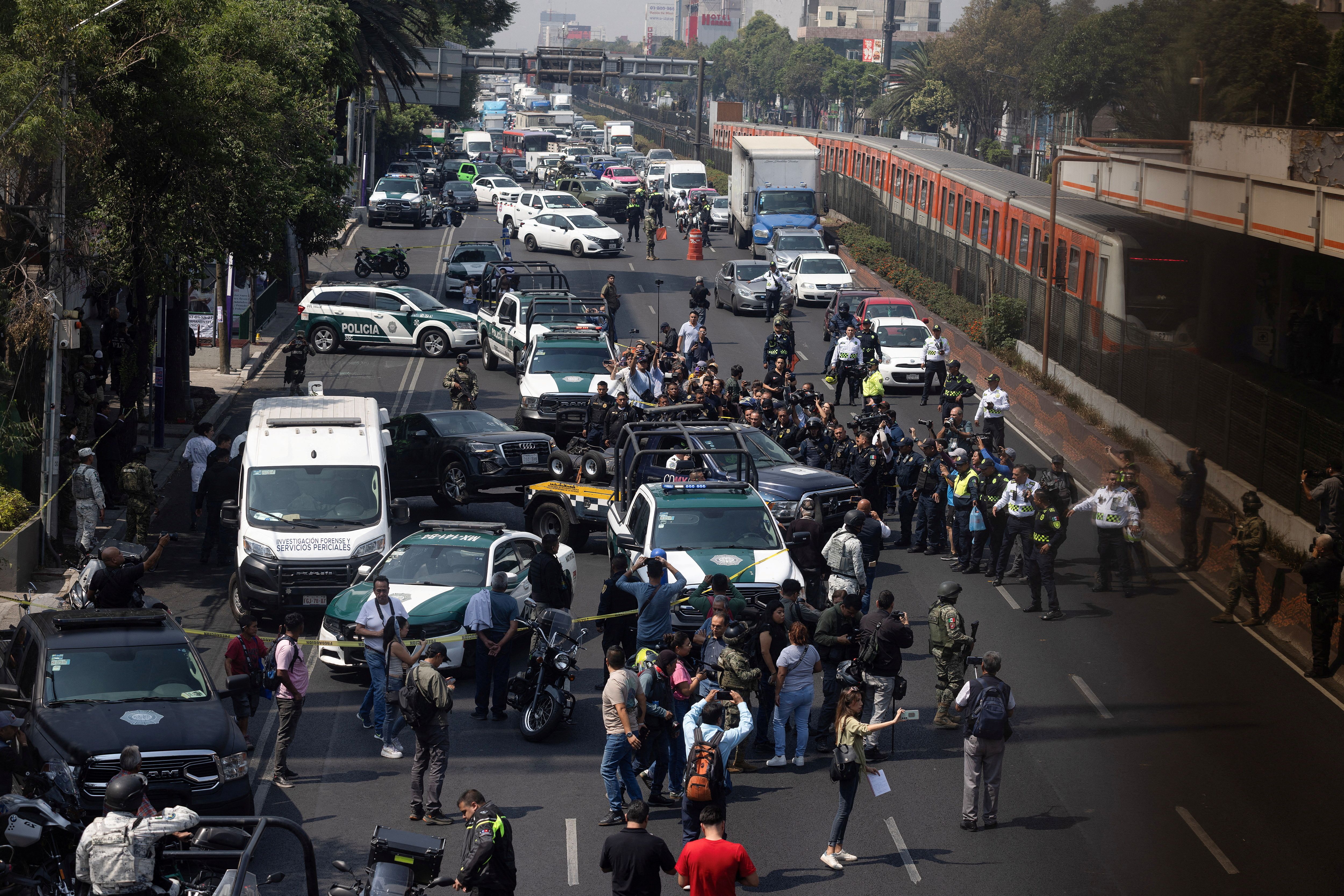 Police officers work at the scene, after two top members of Mexico City Mayor Clara Brugada’s team were killed.