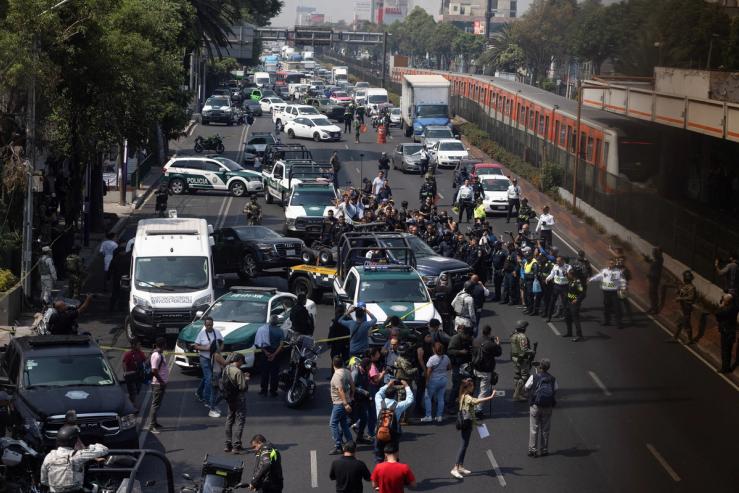 Police officers work at the scene, after two top members of Mexico City Mayor Clara Brugada’s team were killed.
