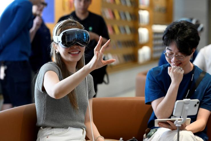 A customer tries on the Vision Pro at the Apple Vision Pro launch in Singapore June 28, 2024.