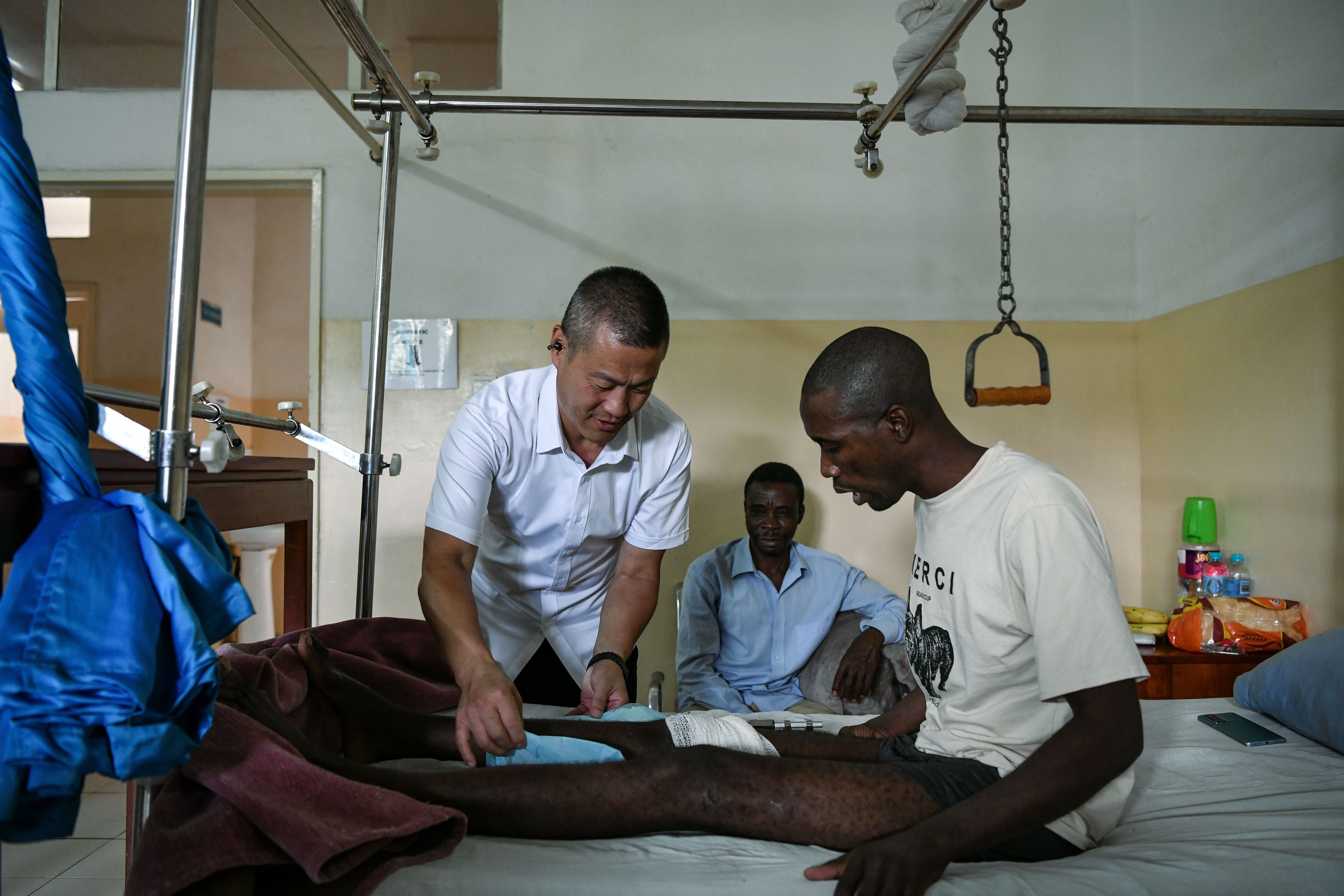 A doctor checks on a patient at a ward of Sinozam Friendship Hospital in Kitwe.