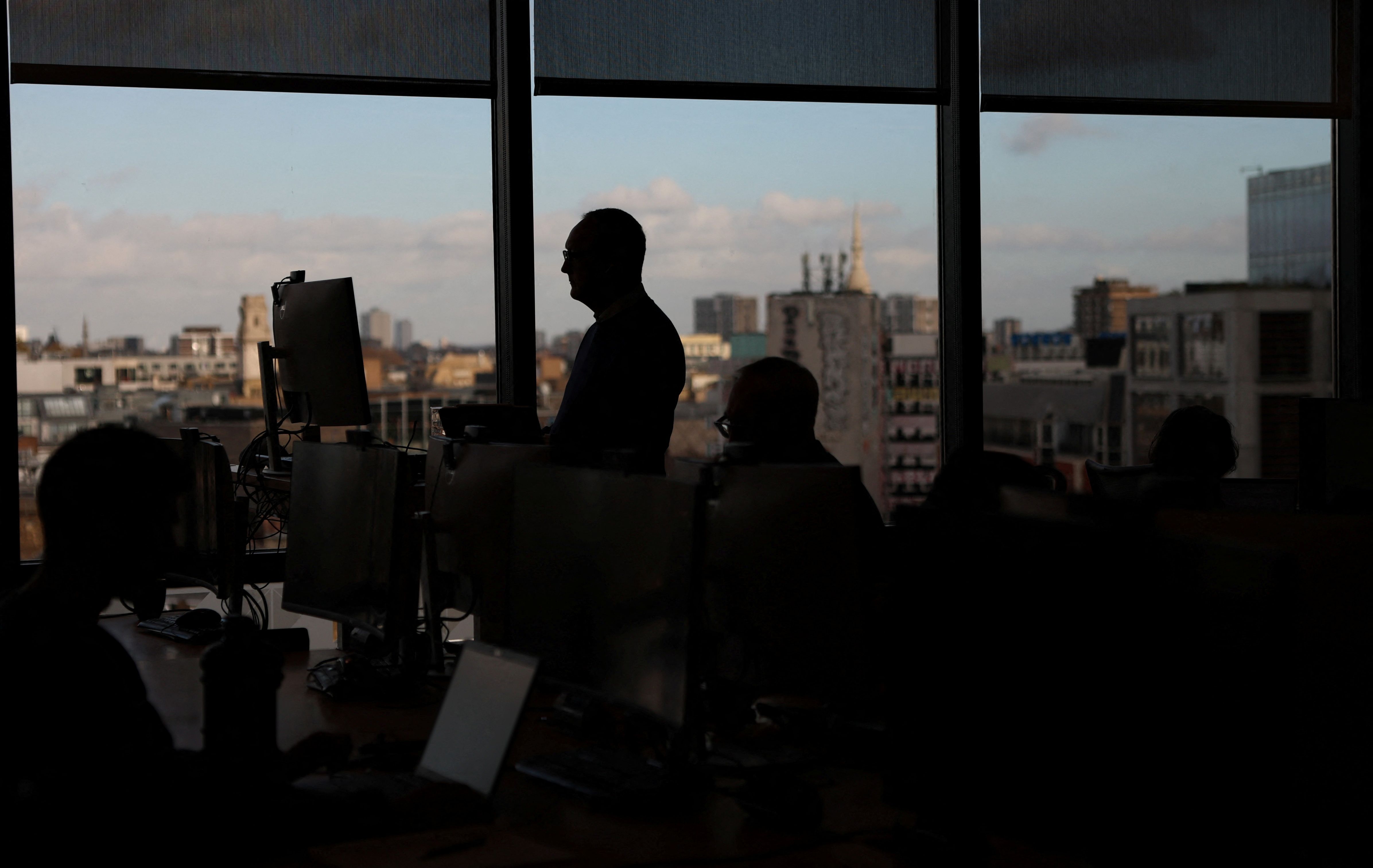 .Employees work on computers in the Moore Kingston Smith office in London, Britain.