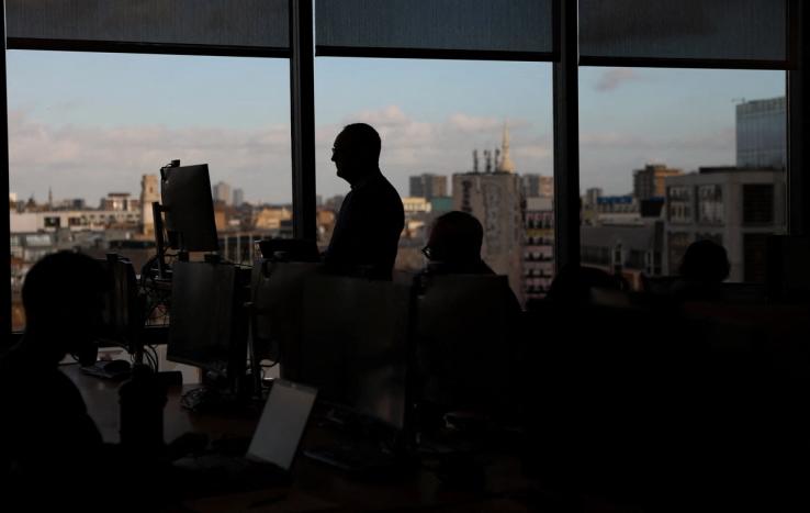 .Employees work on computers in the Moore Kingston Smith office in London, Britain.