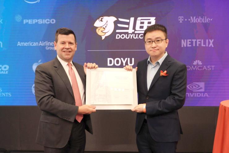 In this handout image, Chen Shaojie, right, founder and CEO of DouYu International Holdings Limited, poses on the Nasdaq stock exchange as DouYu International Holdings LTD initial public offering debuts in New York, USA, 17 July 2019. Chinese video-game live-streaming platform DouYu International Holdings Limited rang the Nasdaq Stock Market opening bell on Wednesday in celebration of its initial public offering (IPO). The company, trading under the ticker symbol of “DOYU,” priced its initial public offering of 67,387,110 American depositary shares (ADSs) at $11.50 per ADS for a total offering size of approximately $775 million, assuming the underwriters their over-allotment option