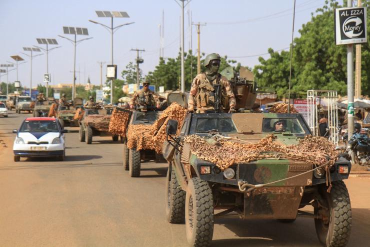 A convoy of French troops based in Niger drives by as they prepare to leave Niger, in Niamey, October 10, 2023.