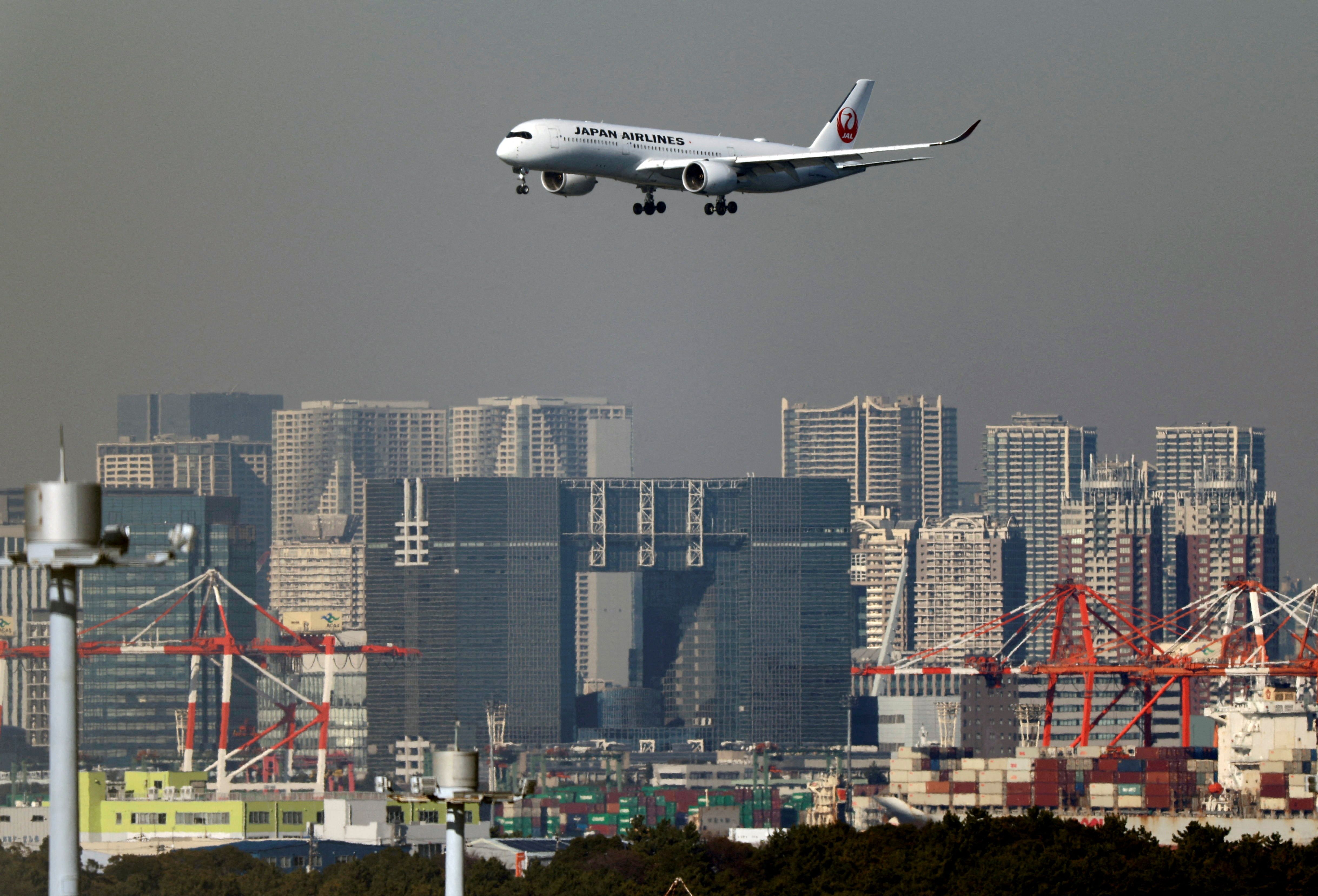  An airplane of Japan Airlines (JAL) approaches to land at Haneda International Airport in Tokyo.