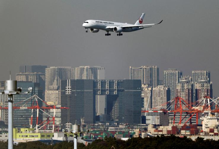 An airplane of Japan Airlines (JAL) approaches to land at Haneda International Airport in Tokyo.