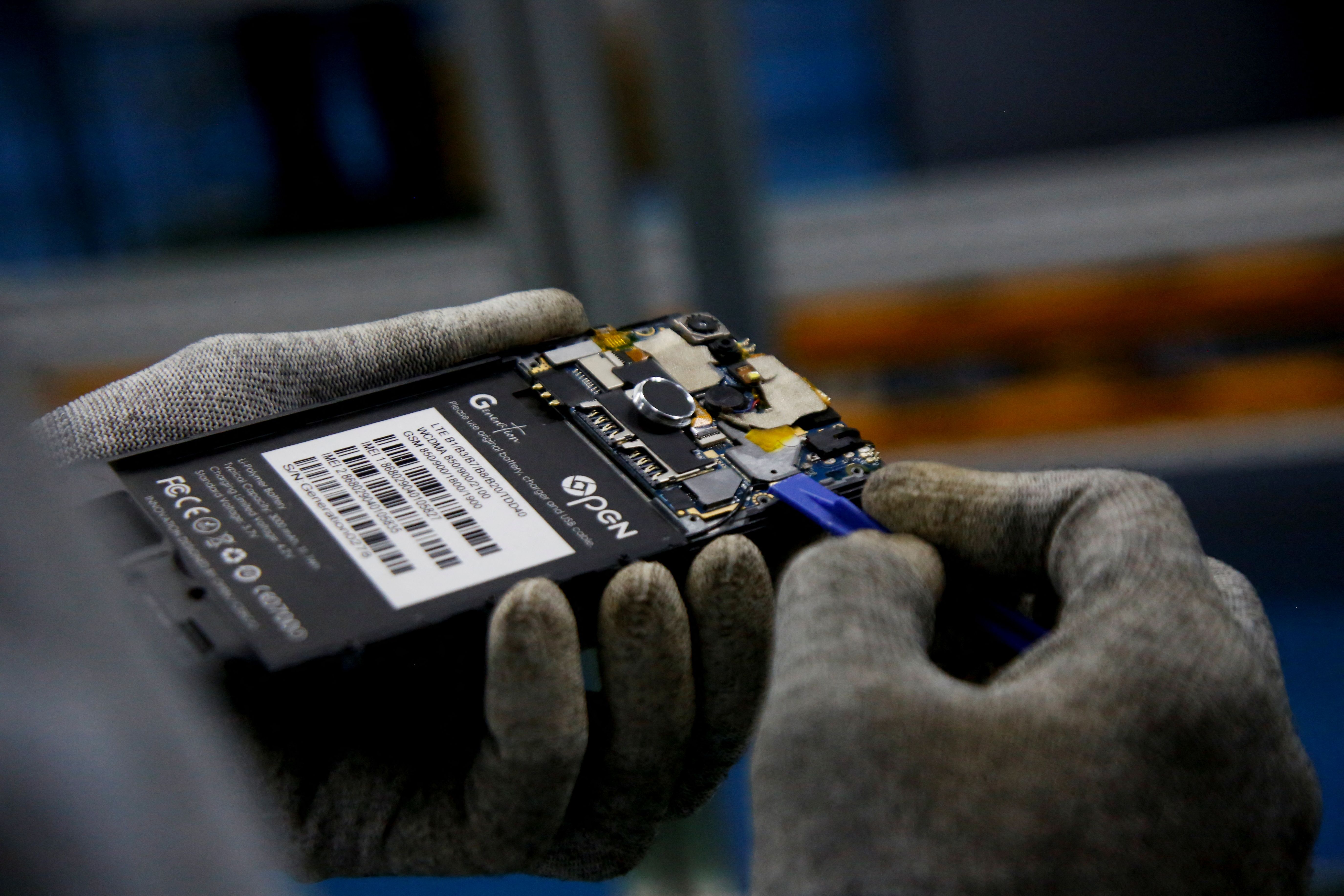 A worker holding a smartphone. 