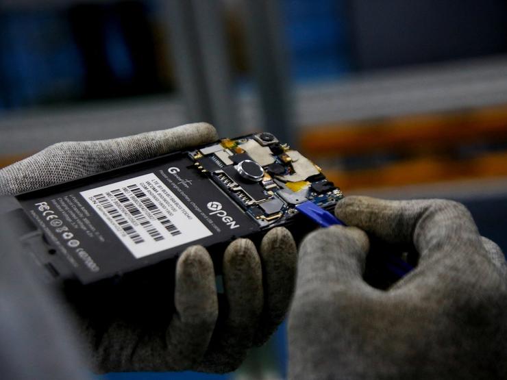 A worker holding a smartphone.