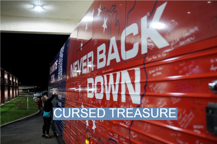 A New Hampshire resident signs Ron Desantis’ campaign bus.