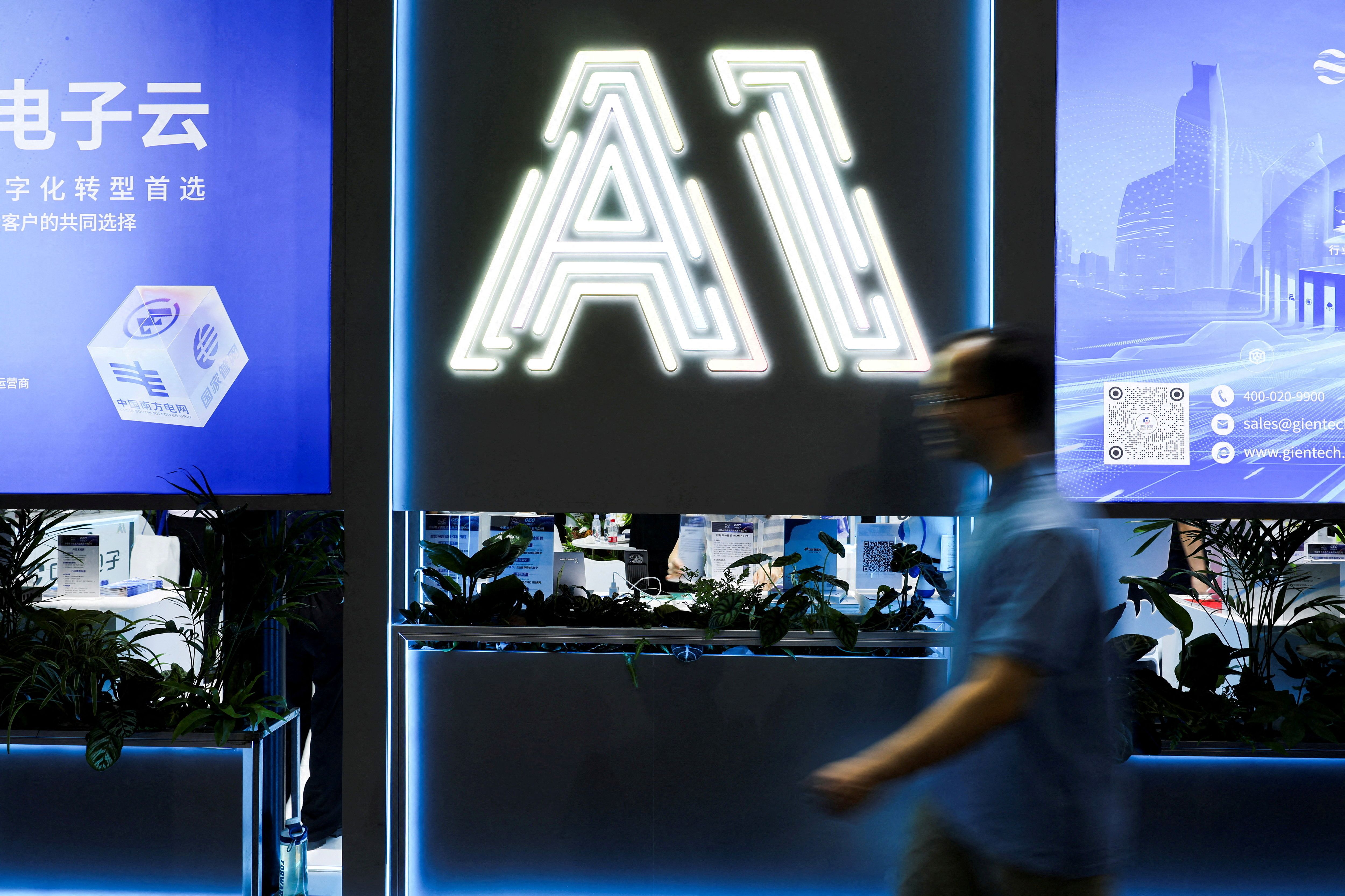 A man walks past an illuminated sign that says AI