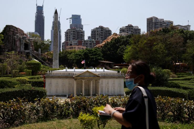A visitor walks past scaled replicas of the White House and the Washington Monument in Shenzhen