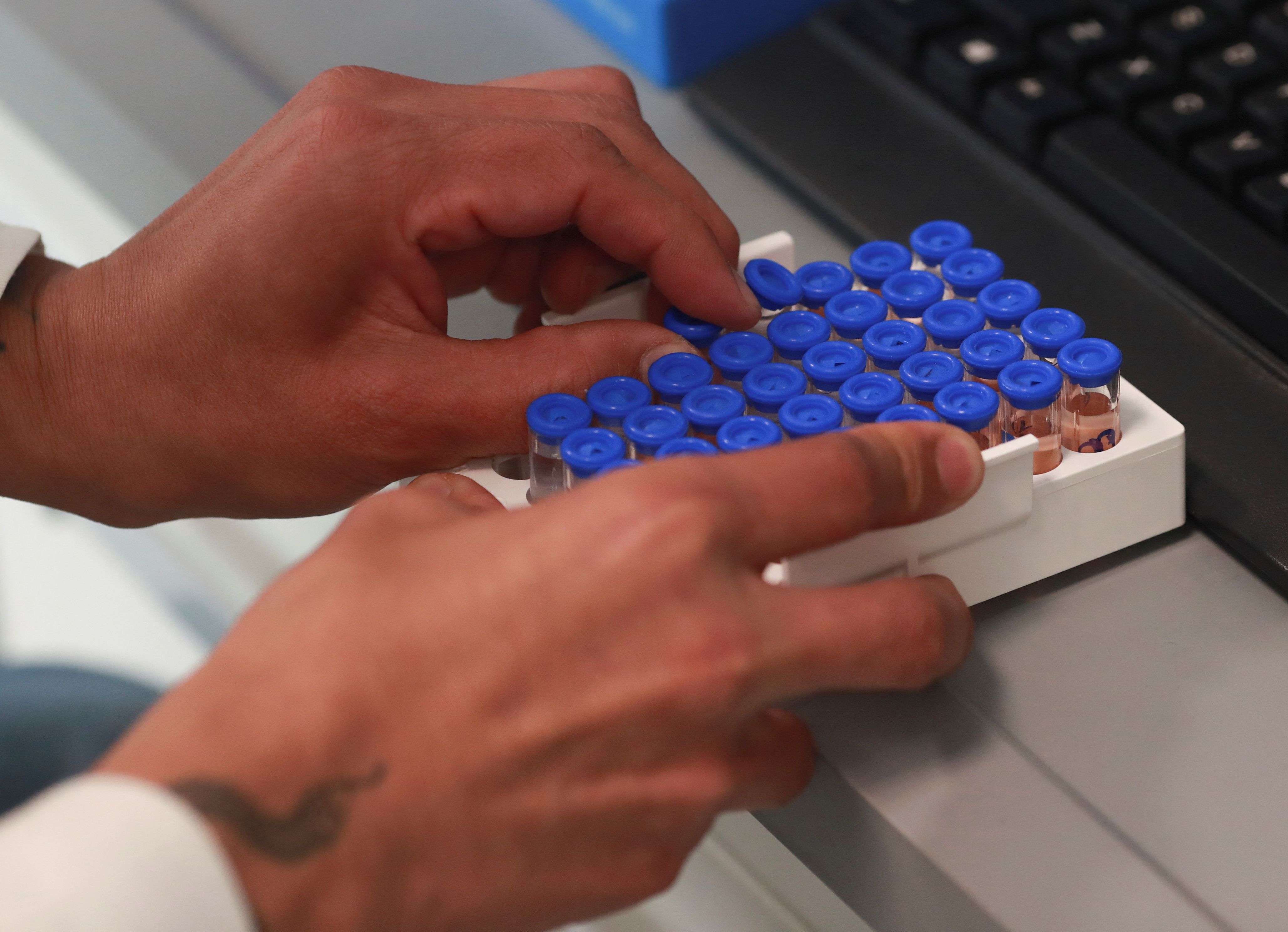 A scientist checks test tubes in a lab at Bayer Mexico’s plant in Lerma