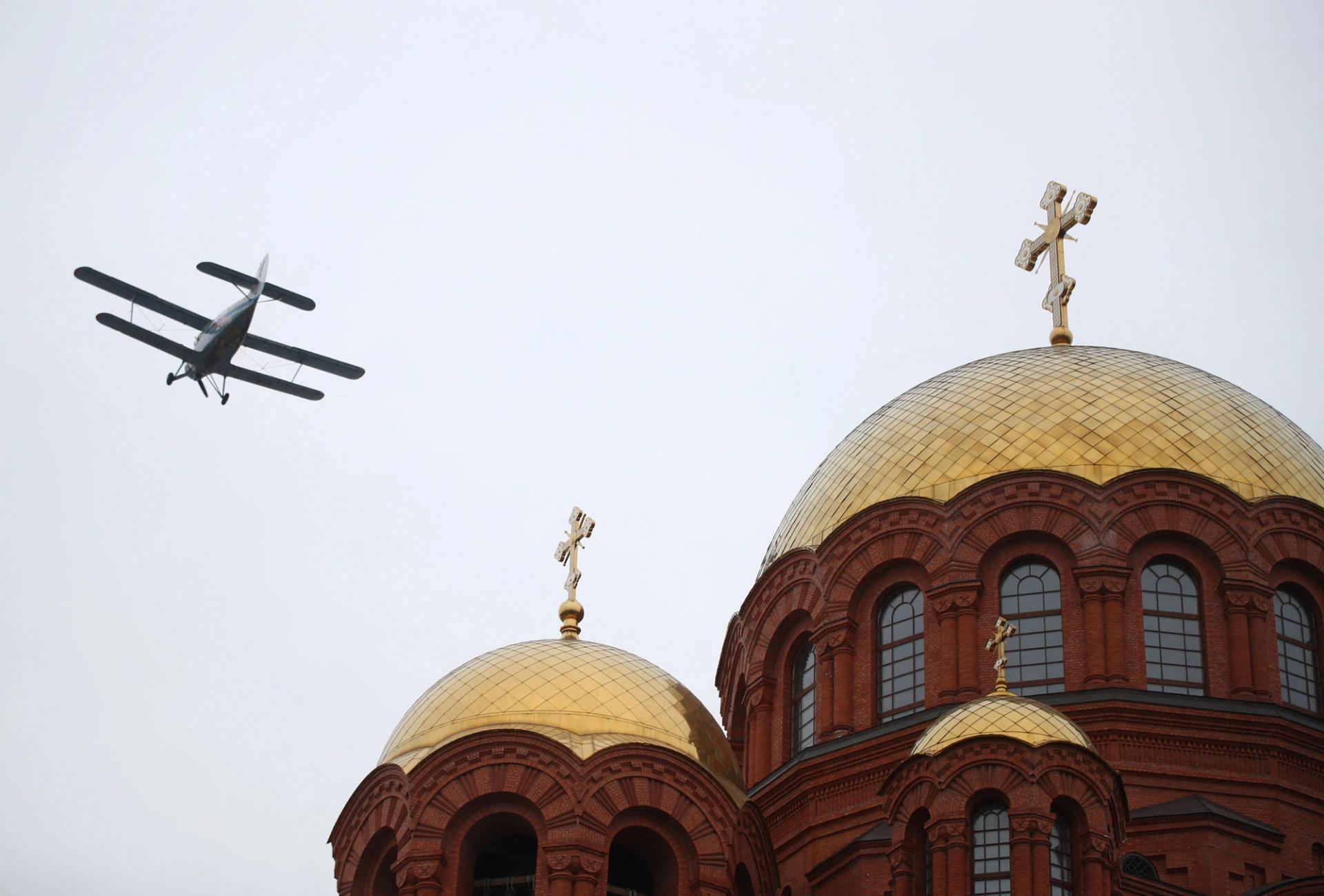 A plane flies over the Cathedral of Alexander Nevsky during a military parade marking the 80th anniversary of the victory of Red Army over Nazi Germany's troops in the Battle of Stalingrad during World War Two, in Volgograd