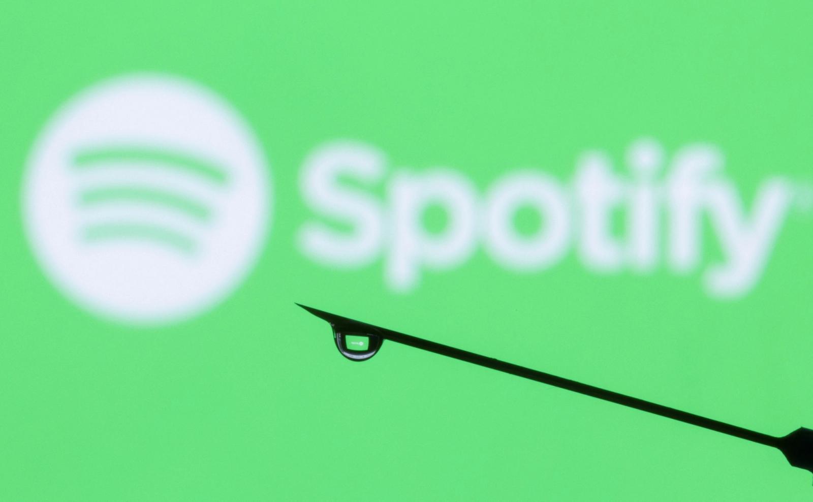 Spotify logo is reflected in a drop on a syringe needle in this illustration taken, January 31, 2022.