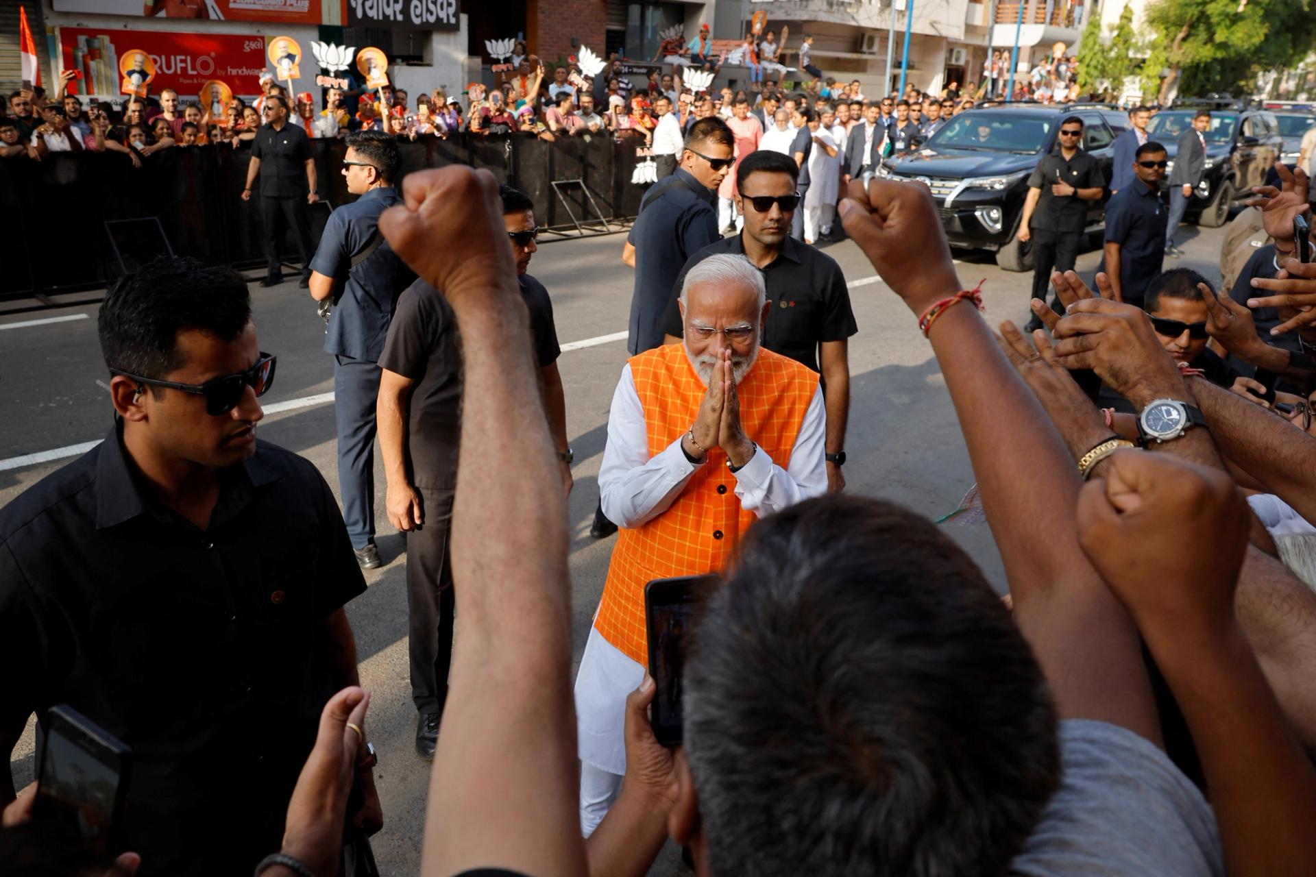 India's Prime Minister Narendra Modi greets people after casting his vote.