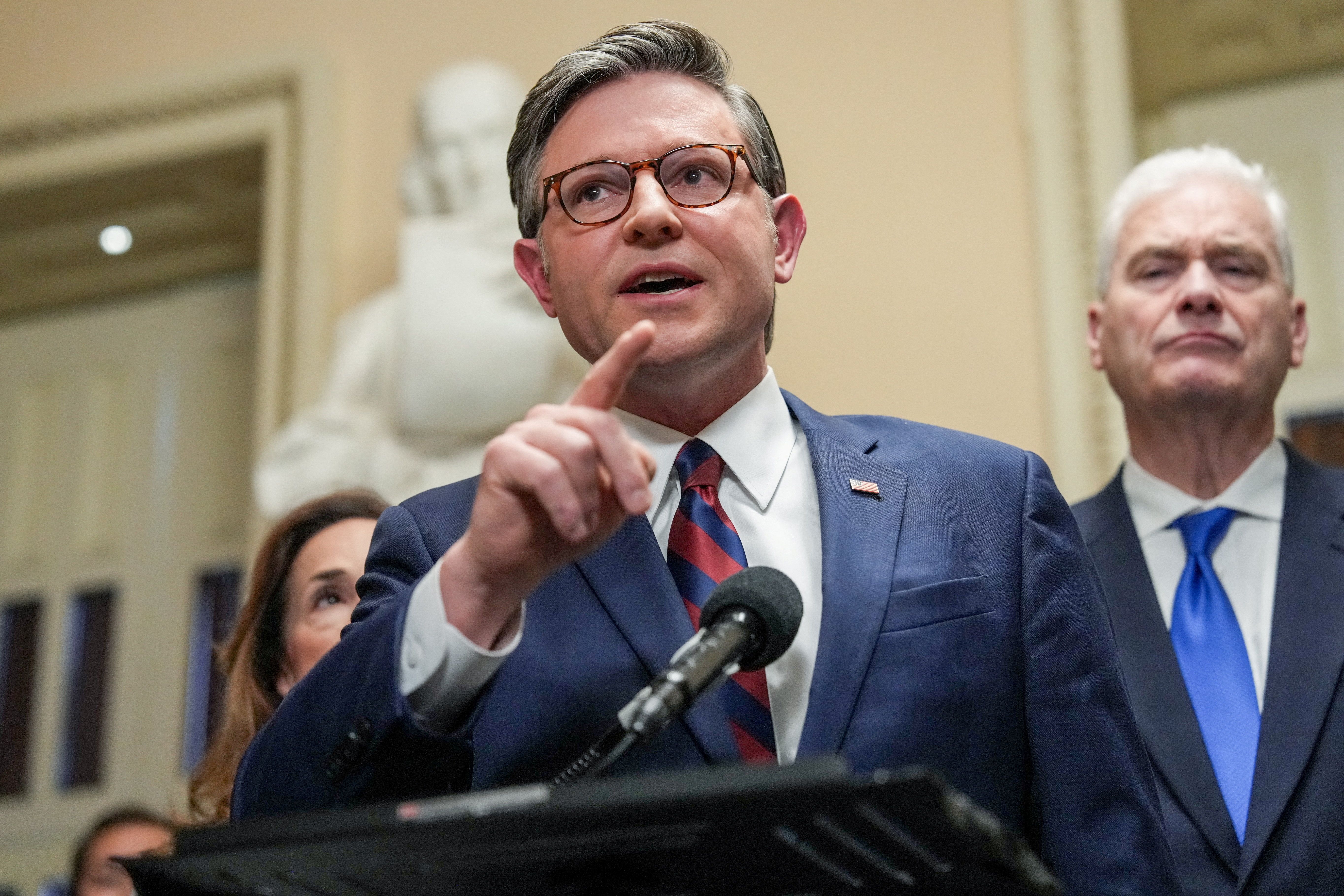 U.S. House Speaker Mike Johnson (R-LA) speaks to the media, flanked by House Republican Conference Chairwoman Lisa McClain (R-MI) and House Majority Whip Tom Emmer (R-MN), after the U.S. Senate voted to end a partial government shutdown that has snarled airports across the country, though it did not resolve a dispute over immigration enforcement that prompted the six-week standoff in the first place, on Capitol Hill in Washington, D.C., U.S., March 27, 2026. 