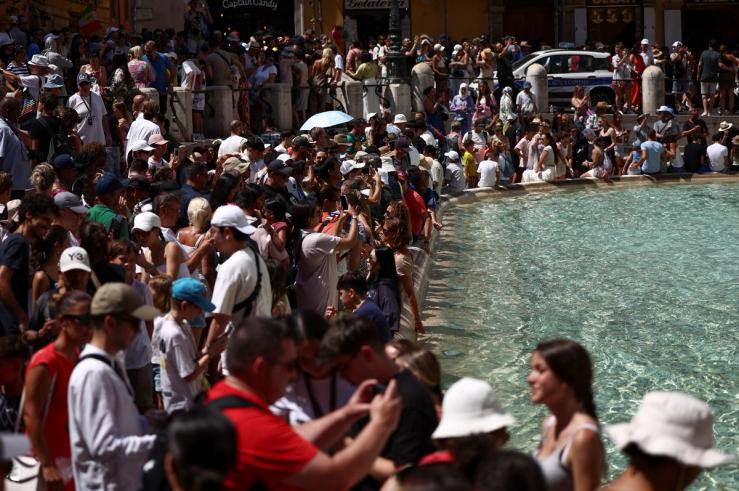 Crowds of tourists visit the Fontana di Trevi in Rome.