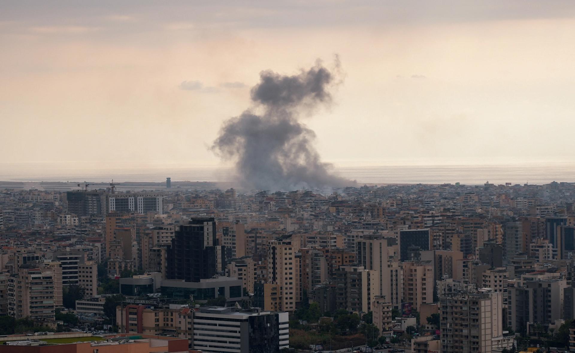 Smoke billows over tall buildings in Beirut after an Israeli strike. 