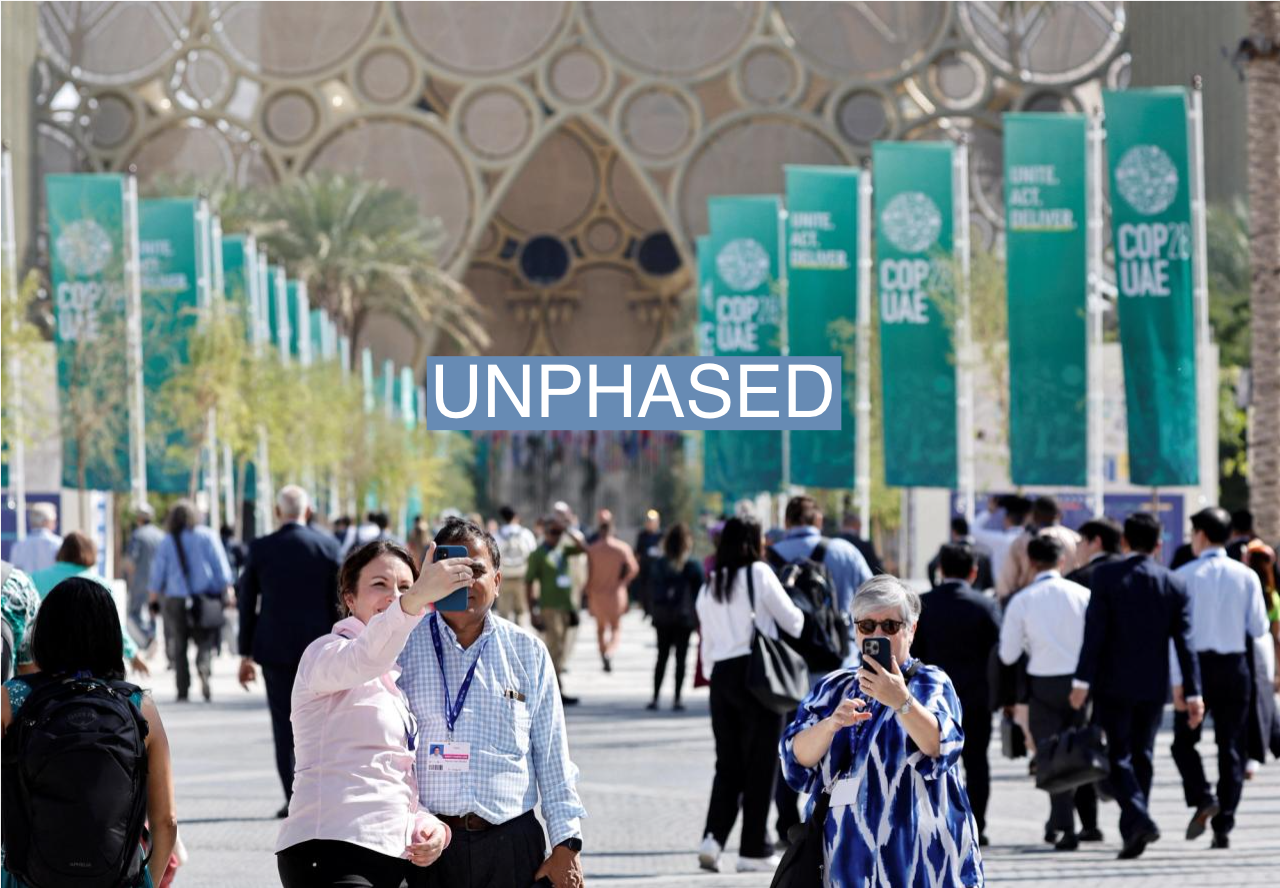 People take pictures during the United Nations Climate Change Conference (COP28) in Dubai, United Arab Emirates, December 1, 2023. REUTERS/Thaier Al-Sudani