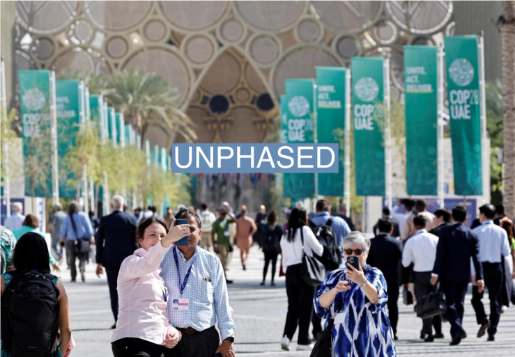 People take pictures during the United Nations Climate Change Conference (COP28) in Dubai, United Arab Emirates, December 1, 2023. REUTERS/Thaier Al-Sudani