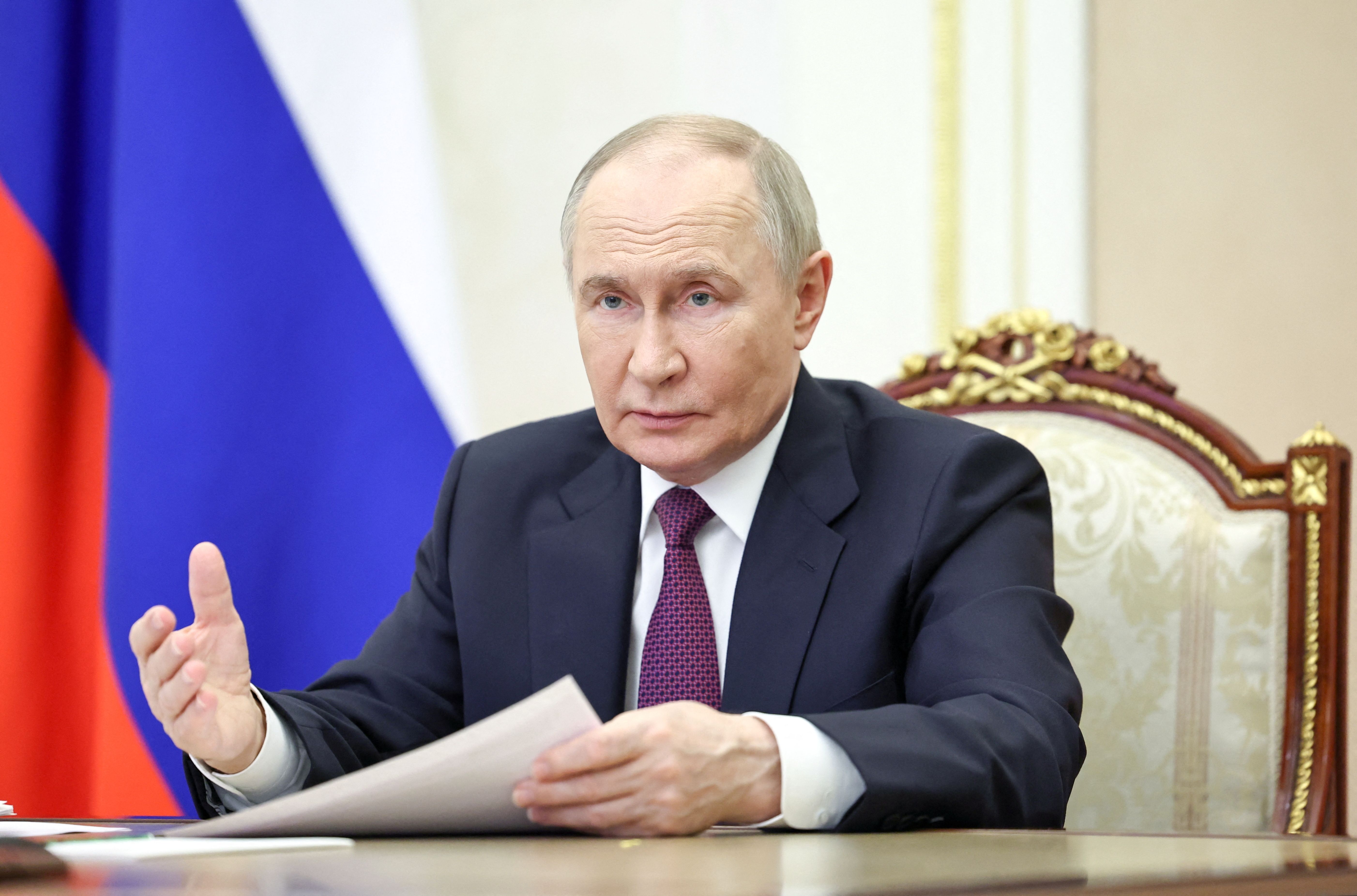 Russian President Vladimir Putin chairs a meeting with members of the government via video link in Moscow.