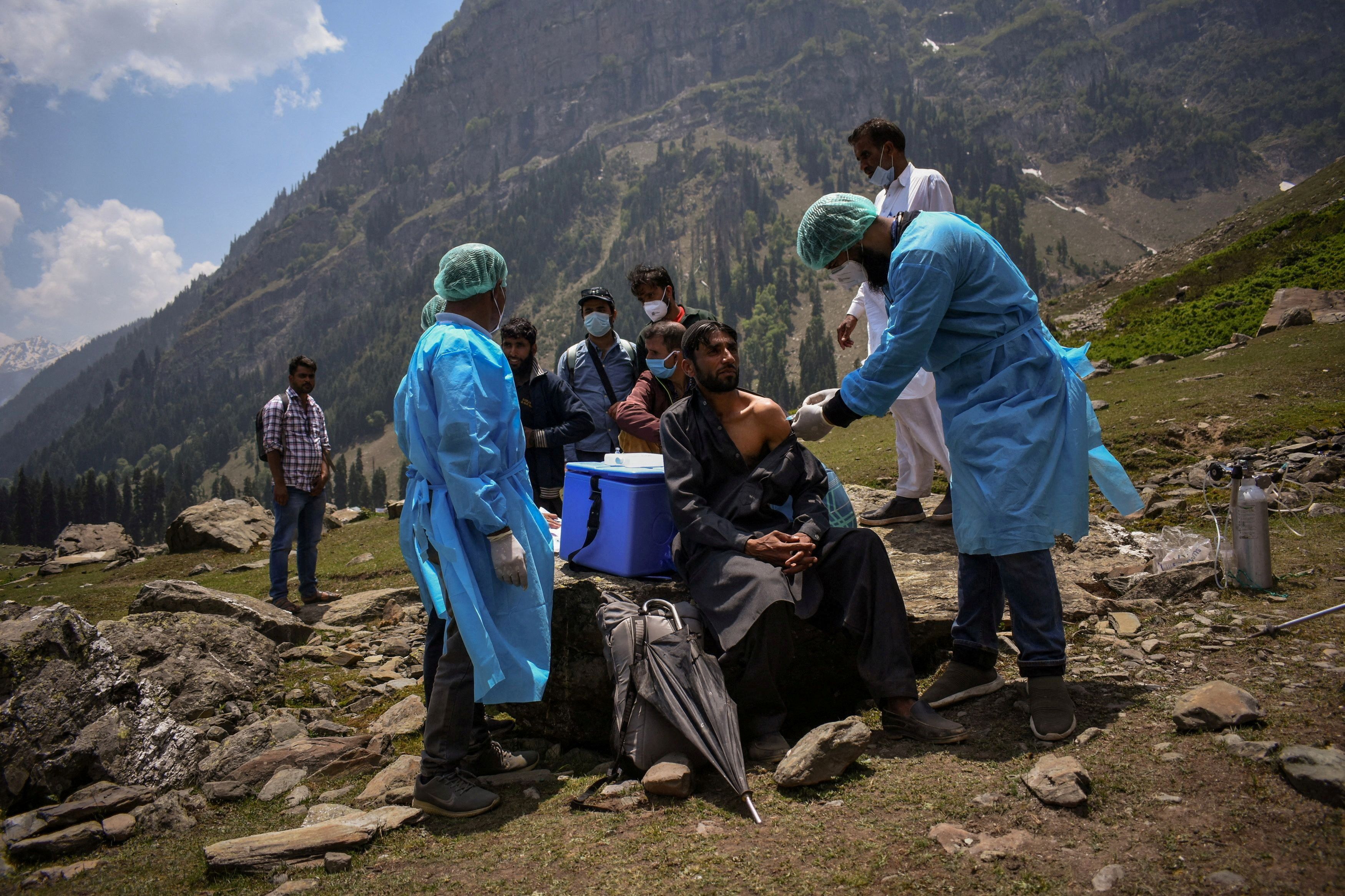 A healthcare worker administers a dose of a coronavirus disease vaccine to a shepherd during a vaccination drive in Kashmir, India.