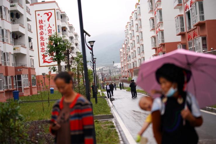 Ethnic Yi women are seen with children at the Chengbei Ganen Community, a residential complex built for a relocation programme as part of China’s poverty alleviation effort.