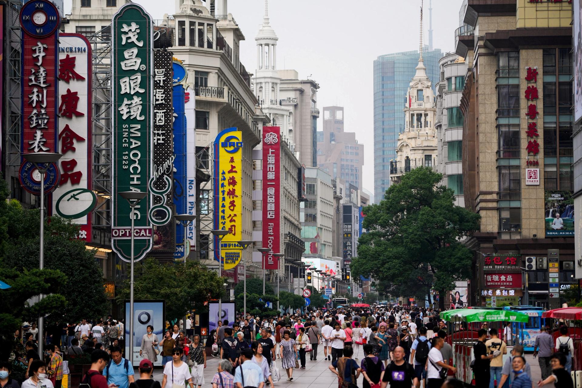 People walk along Nanjing Pedestrian Road, a main shopping area, ahead of the National Day holiday, in Shanghai, China.