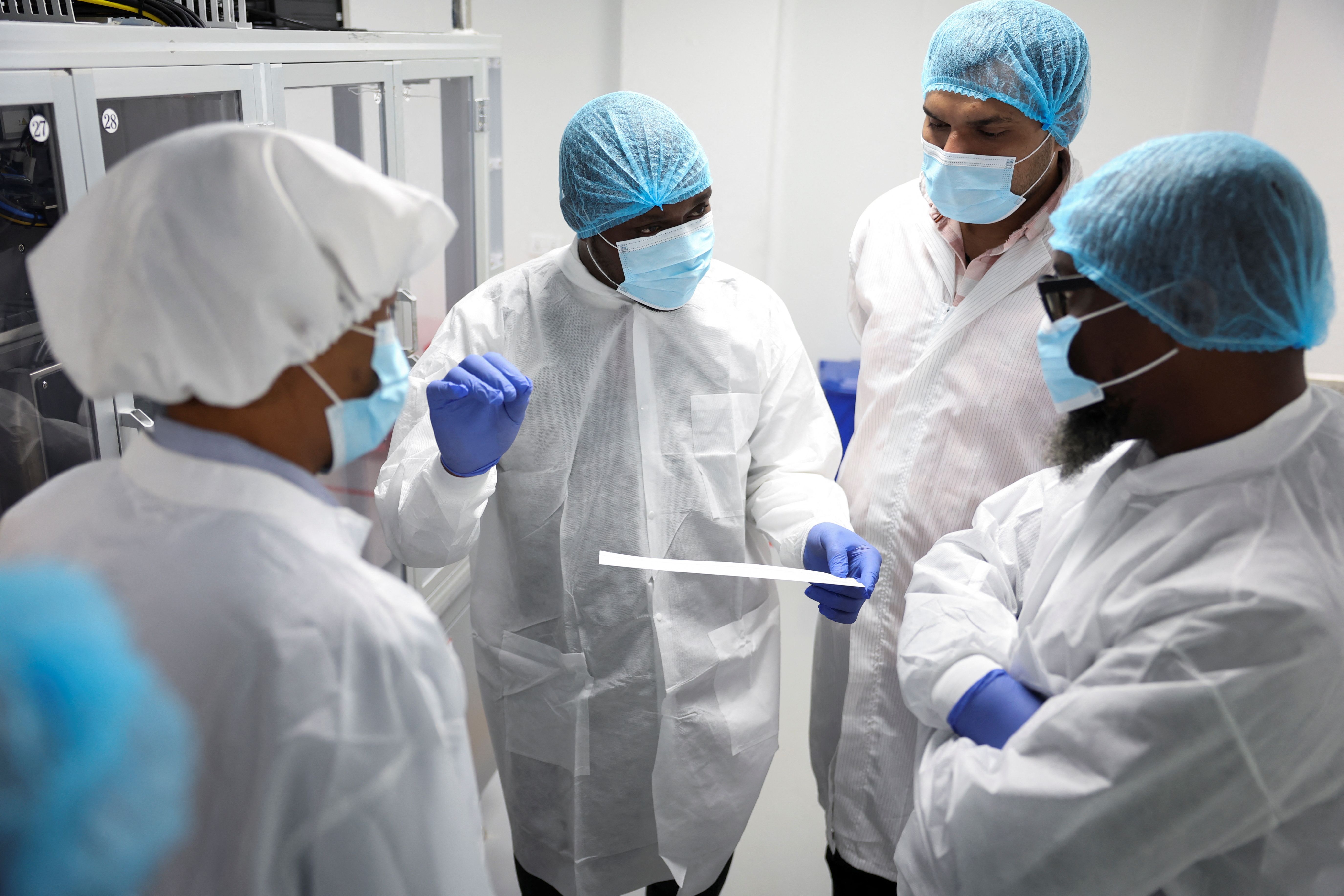 Workers interact at Codix Bio production plant where HIV and Malaria test kits are locally produced.