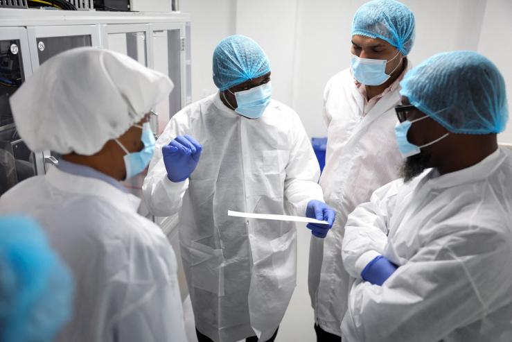Workers interact at Codix Bio production plant where HIV and Malaria test kits are locally produced.