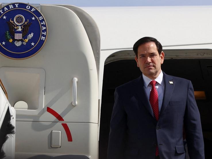 US Secretary of State Marco Rubio disembarks from a plane.