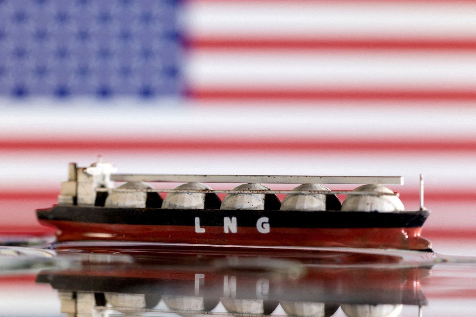 Model of LNG tanker is seen in front of the US flag in this illustration taken May 19, 2022/