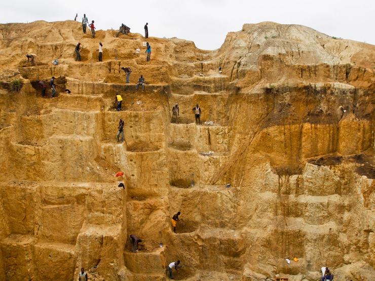 Laborers work at a mine in Minna