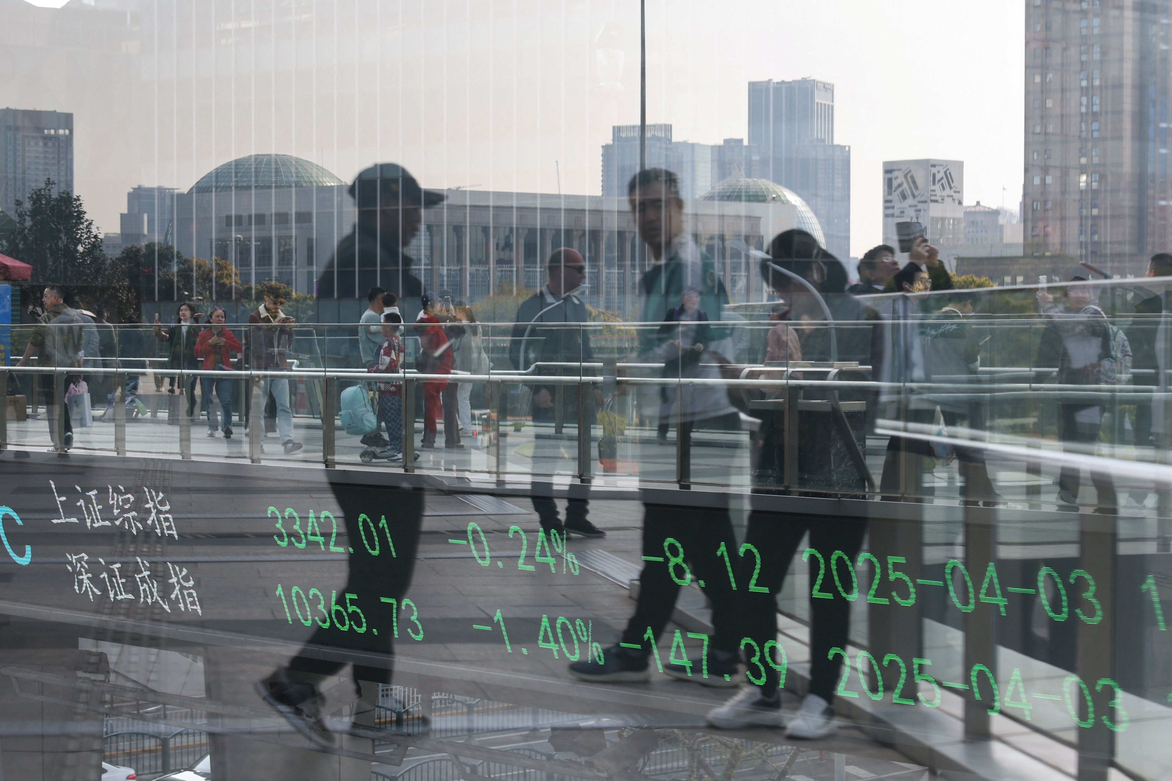An electronic board shows Shanghai and Shenzhen stock indices in Shanghai, China. 