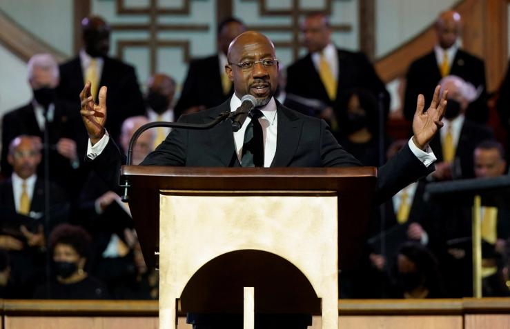 US Senator Raphael Warnock (D-GA), a senior pastor at Ebenezer Baptist Church, speaks ahead of the holiday honoring Martin Luther King Jr., in Atlanta, Georgia, U.S.,