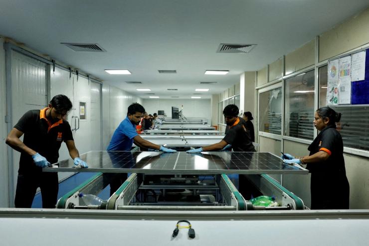 Technicians work on the assembly line in a solar manufacturing hub in Greater Noida, on the outskirts of New Delhi.