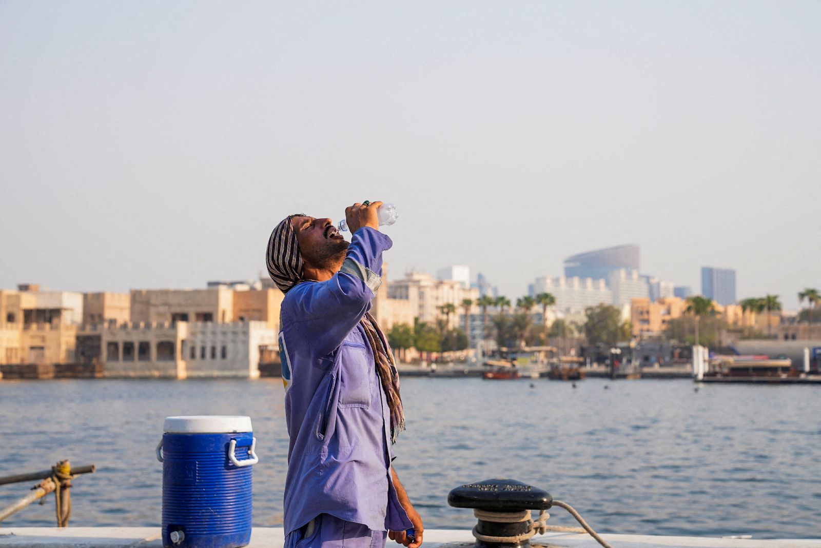 A worker drinks water during a heatwave in Dubai, UAE, July 31, 2025. 