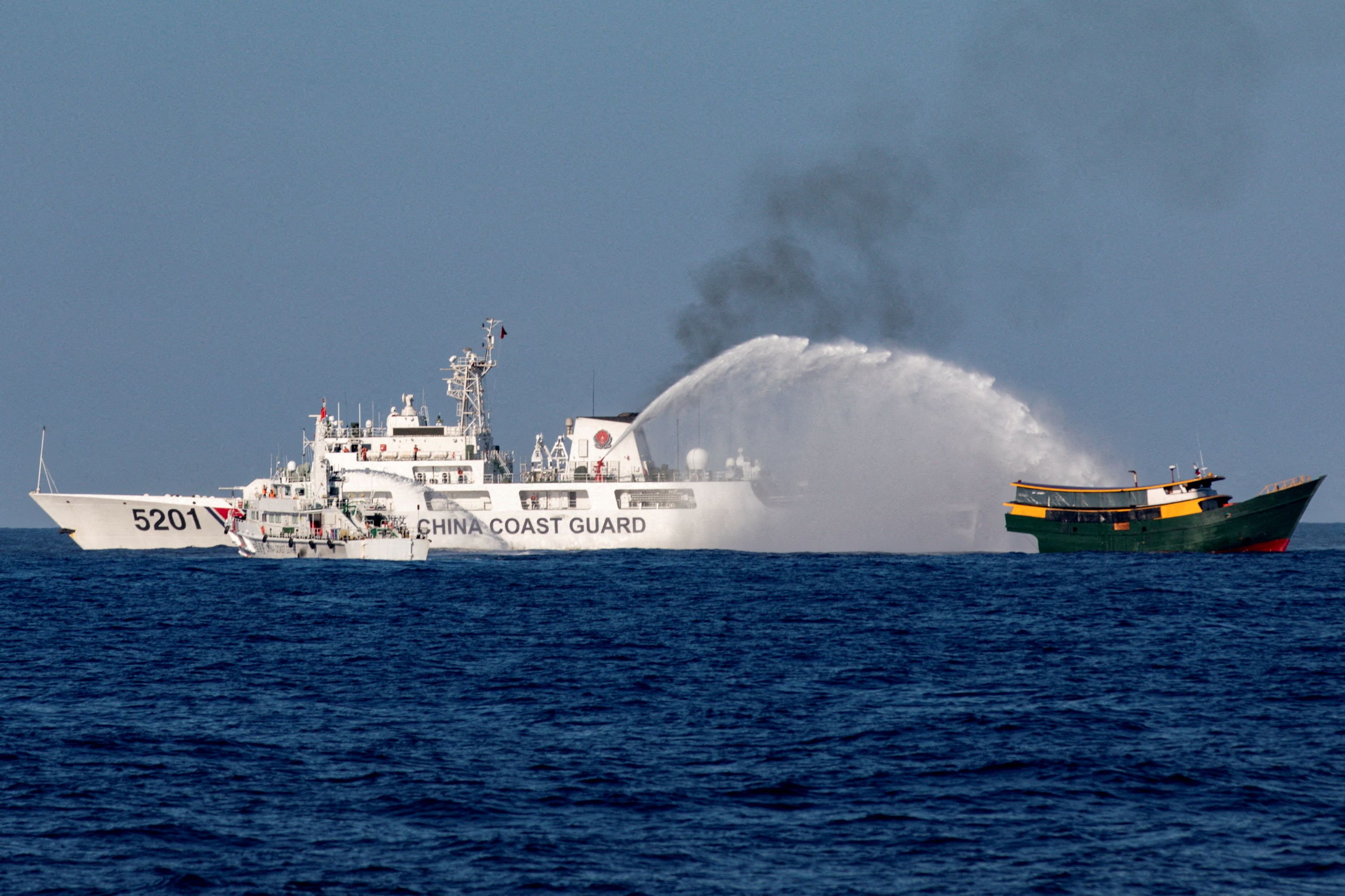 FILE PHOTO: Chinese Coast Guard vessels fire water cannons towards a Philippine resupply vessel Unaizah May 4 on its way to a resupply mission at Second Thomas Shoal in the South China Sea, March 5, 2024. REUTERS/Adrian Portugal/File Photo