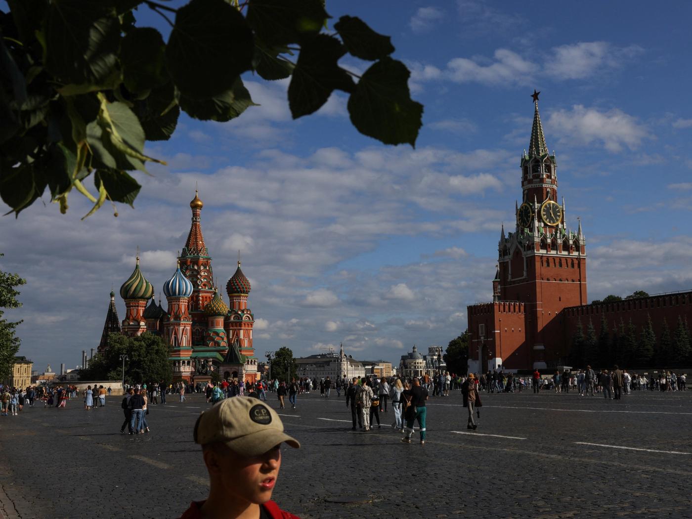 People walk near St. Basil's Cathedral and the Kremlin's Spasskaya Tower in Red Square in central Moscow, Russia July 19, 2023. REUTERS/Evgenia Novozhenina