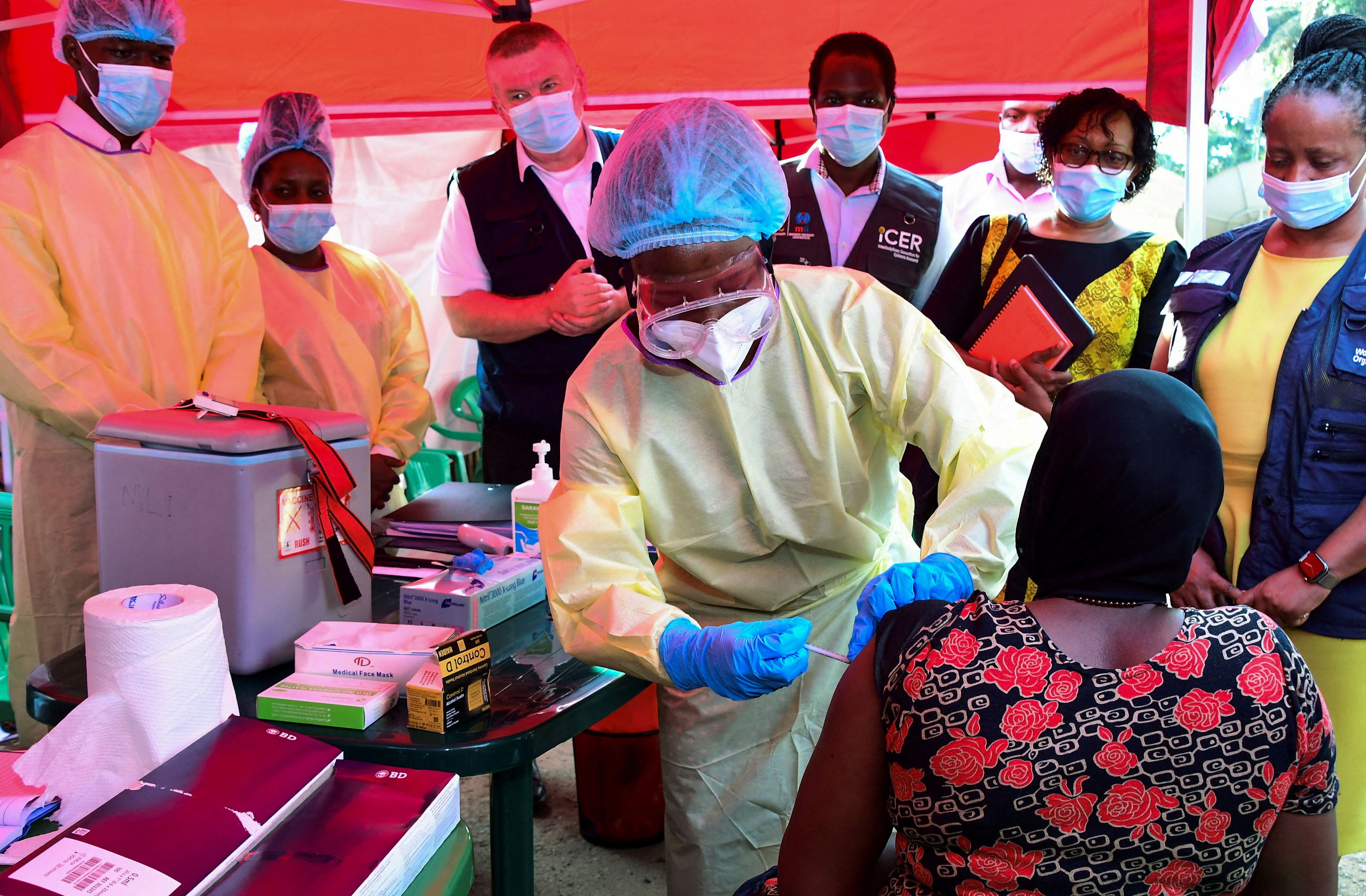 A doctor vaccinates a patient in Kampala, Uganda. 