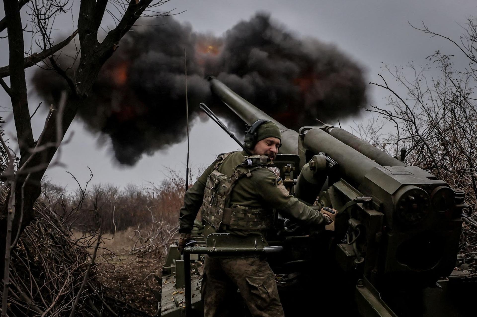 A Ukrainian soldier fires a self-propelled howitzer