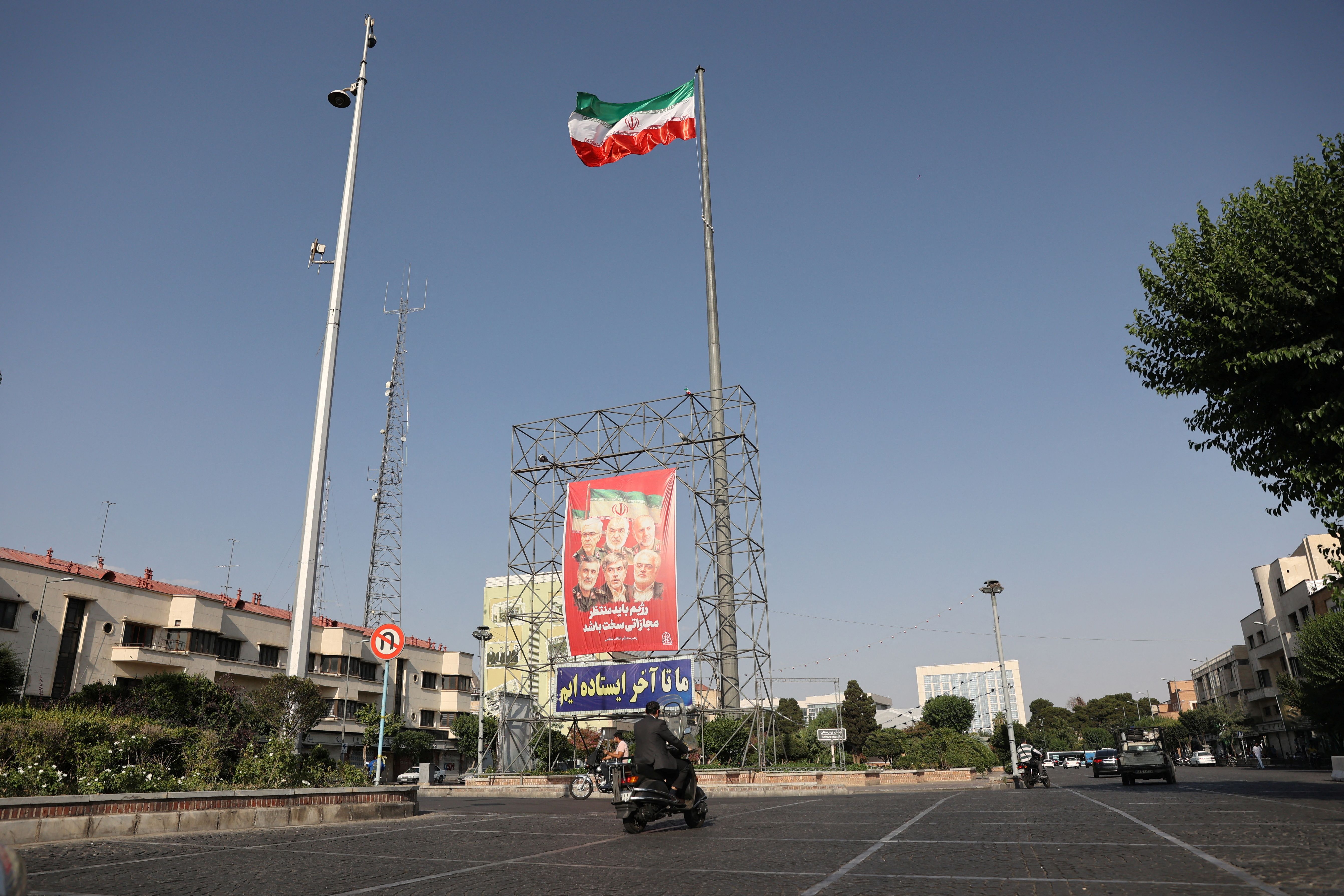 Pictures of those killed in Israeli strikes on Iran are displayed on a street, in Tehran.