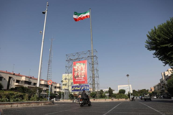 Pictures of those killed in Israeli strikes on Iran are displayed on a street, in Tehran.